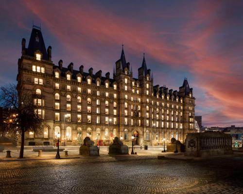 利物浦的住宿－Radisson RED Hotel, Liverpool，一座大建筑在晚上点燃