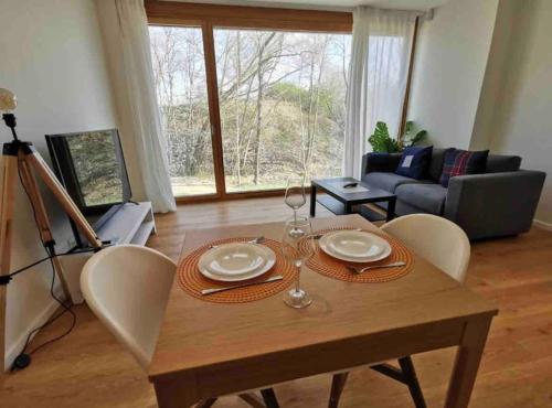 a living room with a wooden table and chairs at New 1 bedroom in Kirchberg, Outdoor & Parking in Luxembourg