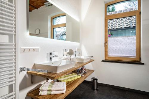 a bathroom with two sinks and a mirror at Käserei in Argenbühl