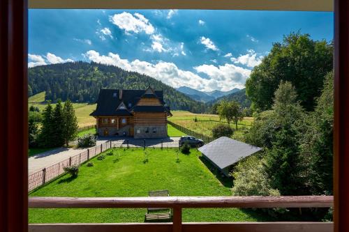 a view of a house in a field of grass at Goga in Zakopane