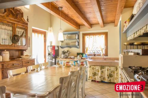 a kitchen with a large wooden table and chairs at B&B I fiori di Marianna in Bergamo