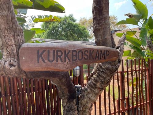 a sign that says kirkbushatown attached to a tree at Oryx Wilderness Game Lodge and Tented Camp in Rhenosterfontein