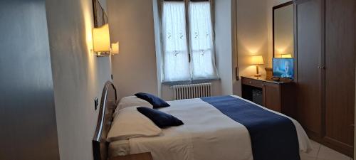 a bedroom with a bed and a window and a television at Hotel Bonazzi in Perugia