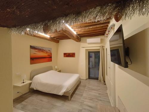 a bedroom with a bed and a tv on a wall at The View - Sunset & Relax - Suite - Appartamenti Vista Lago in Passignano sul Trasimeno