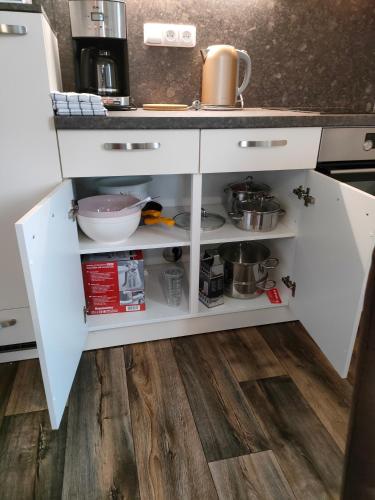 a kitchen with white cabinets and a sink at Penzion Šumava - APARTMÁN in Horní Planá