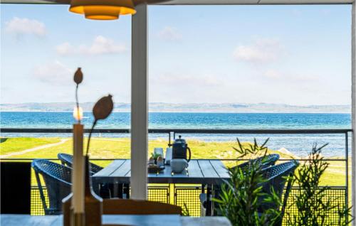 a dining room with a view of the ocean at Apartment Nordre Strandvej in Ebeltoft