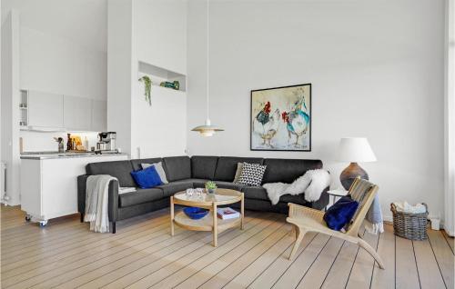 a living room with a couch and a table at Apartment Nordre Strandvej in Ebeltoft