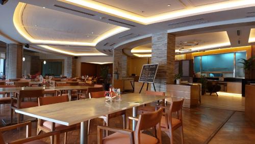 a restaurant with wooden tables and chairs and a chalkboard at Pico De Loro Condo Unit in Nasugbu
