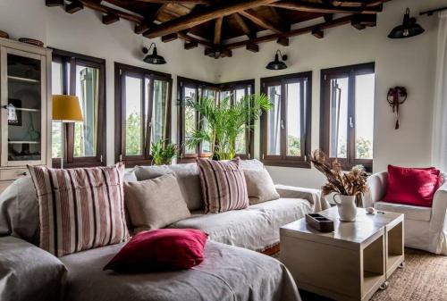a living room with a couch and a table at Villa Melissa Tsagarada in Tsagarada