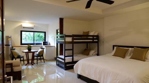 a bedroom with a bed and a desk and a chair at Nara Residence Trang in Trang