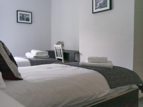two beds in a room with towels on them at Chestnut House- 2 Bedroom house in Ashington, Northumberland in Ashington