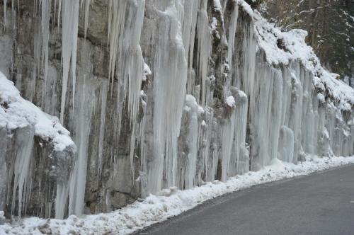 a wall covered in ice and snow next to a road at VILLARD DE LANS in Villard-de-Lans