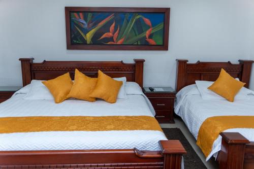 Postel nebo postele na pokoji v ubytování Hotel Aires del Quindío Armenia