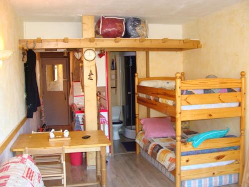 a bedroom with two bunk beds and a desk at VILLARD DE LANS in Villard-de-Lans