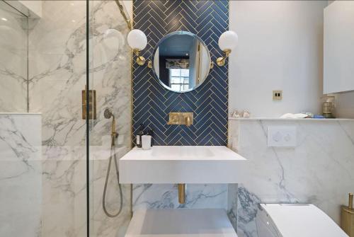 a bathroom with a sink and a shower at Unique Chic Two Bed House Richmond in Richmond upon Thames