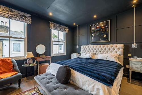 a bedroom with a large bed and a couch at Unique Chic Two Bed House Richmond in Richmond upon Thames