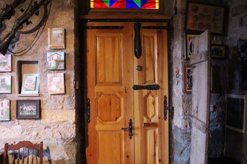 a wooden door in a room with a stained glass window at Stone House with Garden in Cunda/Ayvalik in Ayvalık