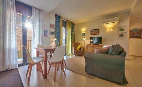 a living room with a couch and a table and chairs at Hotel-Hostal Sport in Falset
