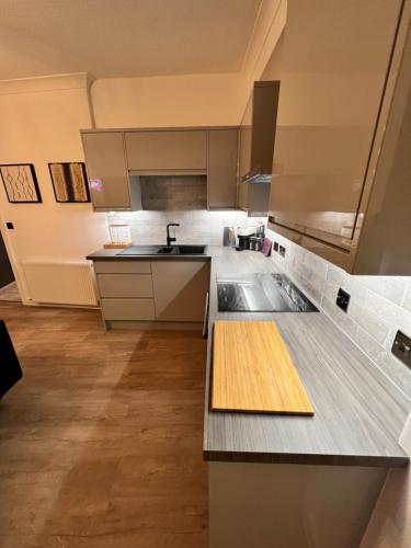 a kitchen with a sink and a counter top at Modern Town-Centre Apartment in Dumfries