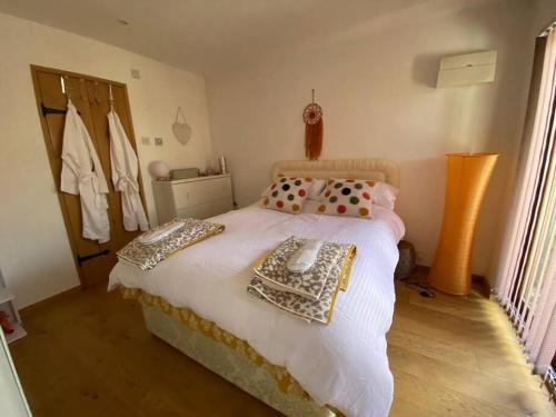 a bedroom with a bed with a phone on it at The Retreat, A relaxing getaway for couples in Hambrook