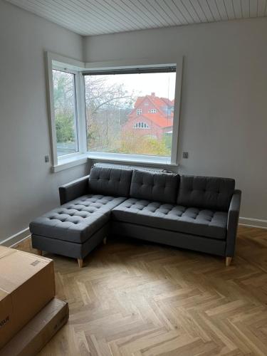 a living room with a couch in front of a window at Great view apartments 1 in Aalborg