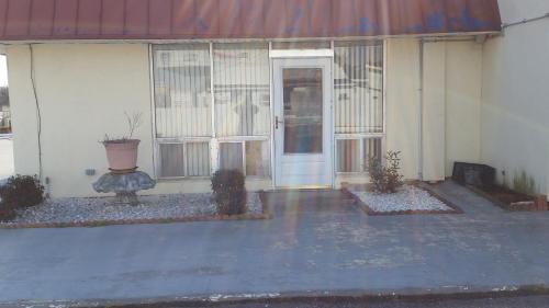 a front door of a house with a plant at Economy Inn Dillon in Dillon