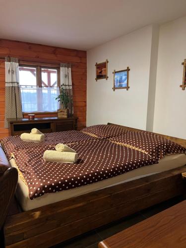 a bedroom with a large bed with two towels on it at BUBLA CITY RANCH in Kopřivnice