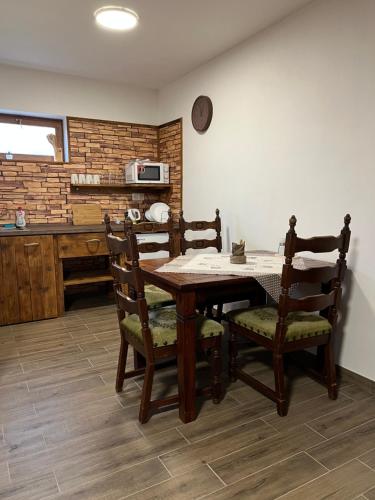 a dining room table and chairs in a kitchen at BUBLA CITY RANCH in Kopřivnice
