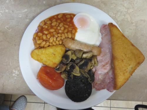 a plate of food with eggs eggs beans and toast at Oakwell Guest House in Bridlington
