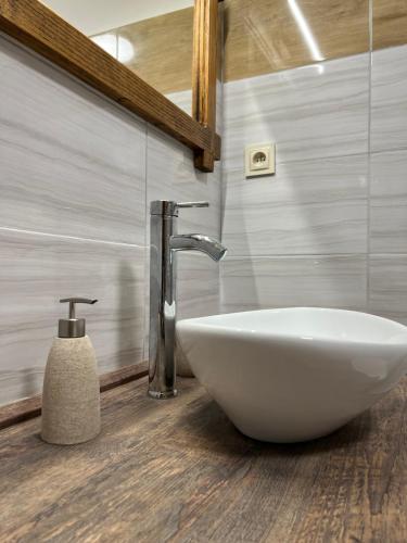 a bathroom with a white sink and a faucet at BUBLA CITY RANCH in Kopřivnice