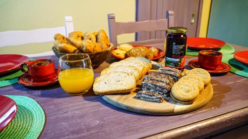 a table with bread and a bottle of orange juice at DandyVillas-Vintage Cottage House-Pelion-Argalasti-Kallithea in KallithÃ©a