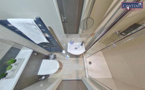 a small bathroom with a toilet and a sink at New House - Magnificent Studios in Coventry City Centre, free parking, by COVSTAYS in Coventry
