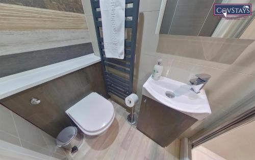 a small bathroom with a toilet and a sink at New House - Magnificent Studios in Coventry City Centre, free parking, by COVSTAYS in Coventry