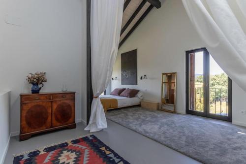 a bedroom with a bed and a large window at Larraetxea in Isla Becoa