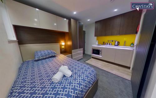 a bedroom with a bed with two towels on it at New House - Magnificent Studios in Coventry City Centre, free parking, by COVSTAYS in Coventry