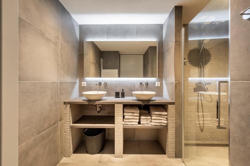 a bathroom with two sinks and a shower at Holiday Apartment Zee in Noordwijk