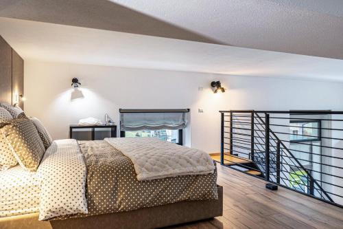 a bedroom with a bed and a staircase at Loft Casa Facco in Bocenago