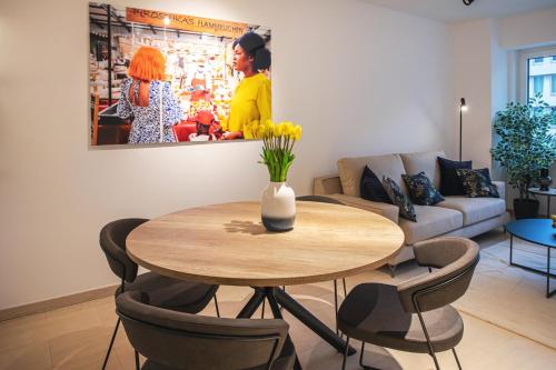 a living room with a table and a couch at Hamilius Apartments City Center Luxembourg by Rentaroo in Luxembourg