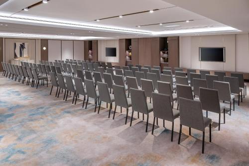 a row of chairs in a room with a screen at Address Beach Resort Bahrain in Manama