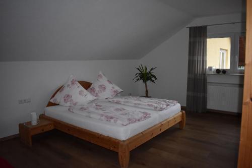 a bedroom with a bed with pink pillows at Ferienwohnung Wiedergrün in Durbach