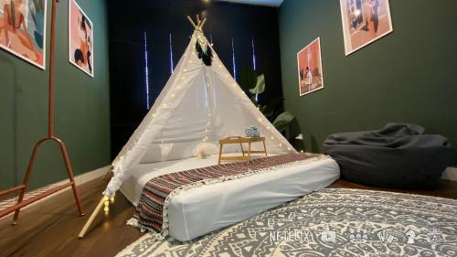 ein Schlafzimmer mit einem Bett und einem Zelt darauf in der Unterkunft Urban Campfire Parc3 by Offweek in Kuala Lumpur