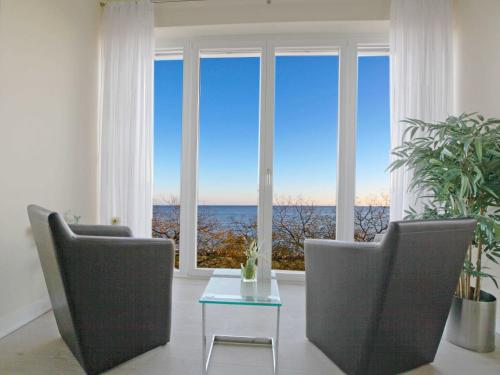 a living room with a view of the ocean at Ostseeresidenz Sassnitz F548 WG 16 mit Kamin, Sauna, Meerblick in Sassnitz