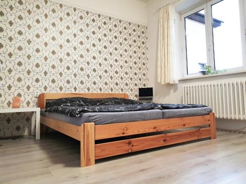 a bedroom with a bed with a wooden frame at Brno apartment in Brno