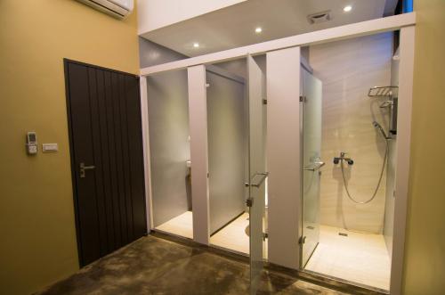 a bathroom with a shower with a glass door at Arch Inn in Hualien City