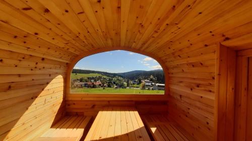 an inside view of a wooden sauna with a window at Aparthotel Teddy Kvilda in Kvilda