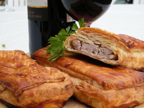 a group of pastries on a table with a bottle of wine at Hotel Universal Murcia in Murcia
