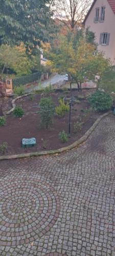 a brick road with a garden with trees and a house at Winzerhaus Rissweg 15 in Dresden