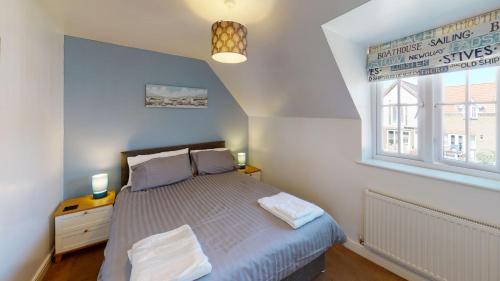 a bedroom with a bed and a window at Anchor Down at The Bay, sleeps 4-6 in 2 bedrooms, dogs welcome too in Filey
