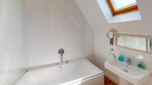 a white bathroom with a sink and a bath tub at Anchor Down at The Bay, sleeps 4-6 in 2 bedrooms, dogs welcome too in Filey
