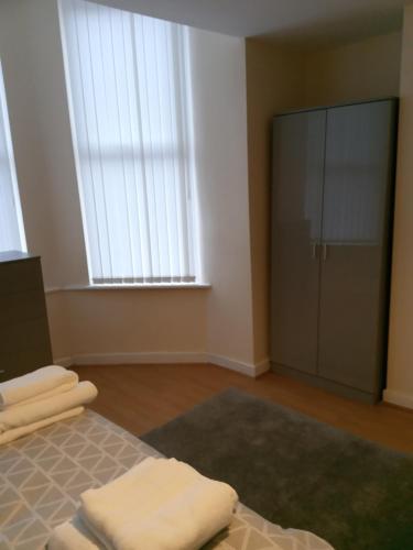 a bedroom with a bed and a large window at Sandringham House in Liverpool